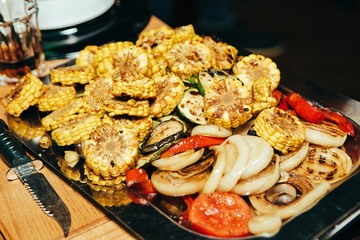 Grilled vegetables pepper corn tomato onion eggplant zucchini on table background
