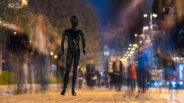The black dummy standing on the crowd street. evening time