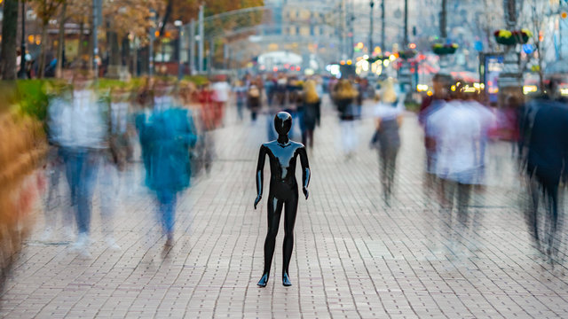 The dummy standing on the street among the stream of people