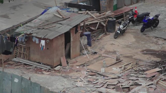 Small ugly shack in the middle of the city. A shack for construction workers to rest, an unsanitary place for people to work and rest.