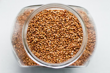 Buckwheat in a glass jar for storage. Buckwheat for making porridge