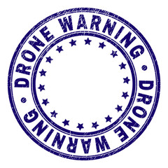 DRONE WARNING stamp seal imprint with grunge texture. Designed with round shapes and stars. Blue vector rubber print of DRONE WARNING text with grunge texture.
