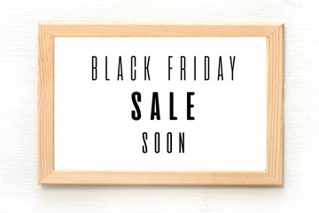 Black Friday sale poster in wooden frame hanging on the wall. Black text on white background.  Vector illustration for sale booklets, price tags. leaflets, flyers, invitation cards, web banners 