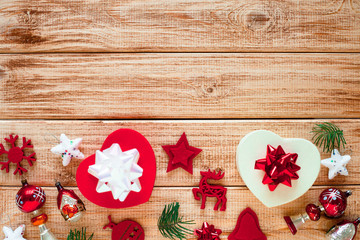 Christmas decorations and gifts on the wooden background. Fir-tree with red ornaments. 