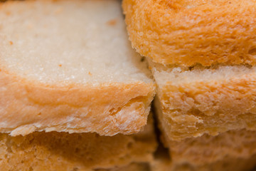 Background crust bread. Fragrant baking. Soft and fresh piece of bread.
