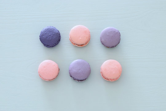 Top view of colorful macaron or macaroon over pastel blue background. Flat lay.