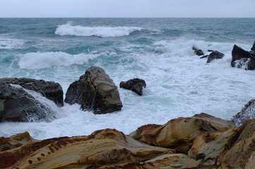 Closed up image of rolling waves with interesting rocks