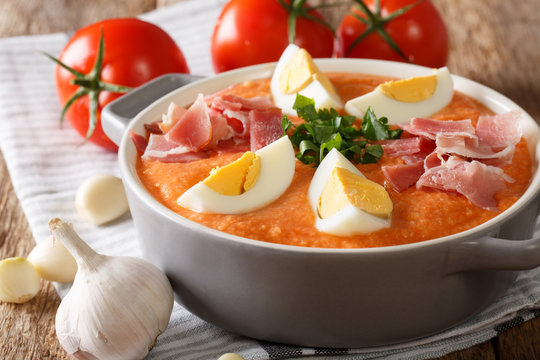 Traditional Porra antequera vegetable puree soup with boiled eggs and serrano ham close-up. horizontal