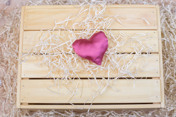 Background of boards with pink silk heart