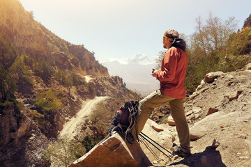 Hiker eating during hike on the mountain pass in the Upper Mustang in Nepal.
