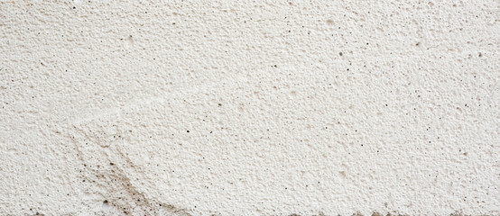 Close-patterned surface and a rough white concrete.