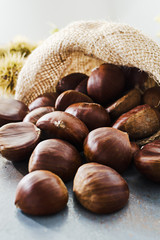 Chestnuts on old grey rustic table with copyspace.