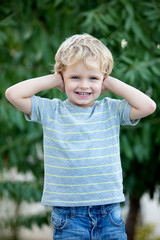 Happy child with blue t-shirt in the garden