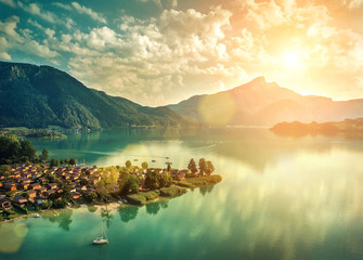 Beautiful morning sunrise view on the mountain lake in Alps under sun