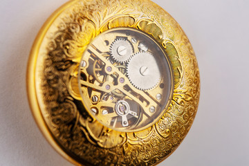 the inside of a classic watch gear wheels of a pocket watch