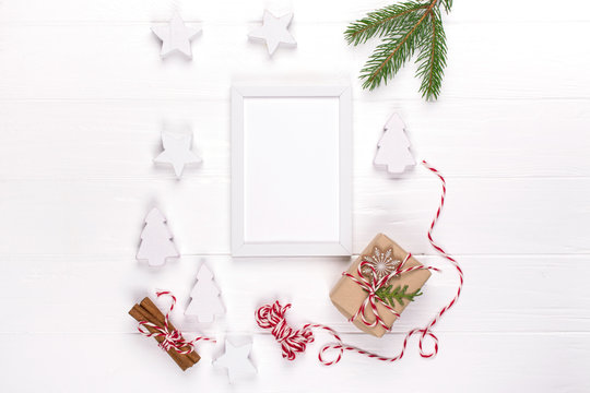 Christmas mock up with photo frame, eco gift boxes and tree branches. New year celebration, holiday concept. Flat lay, top view, copy space