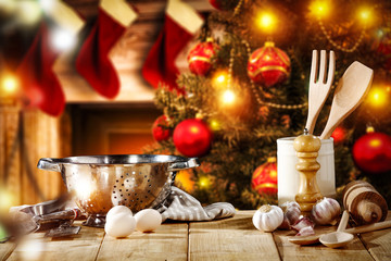Cook hat on table and christmas tree with fireplace 