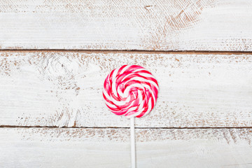 Red and white striped lollipop, table high angle view