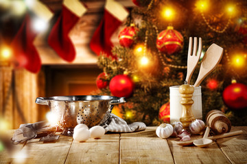 Cook hat on table and christmas tree with fireplace 