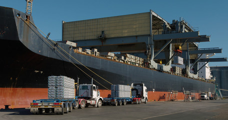 Trucks lining up to export aluminum from Australian port.
