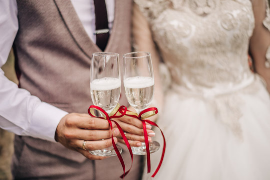 Glasses with champagne in their hands. Wedding background.