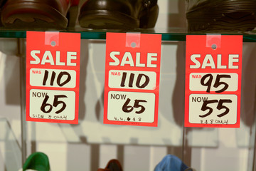 Sale sign in womens shoe store - with before and after sale prices