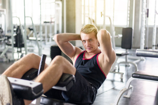 Man doing situp or crunches in gym,Men exercise muscular his stomach in door