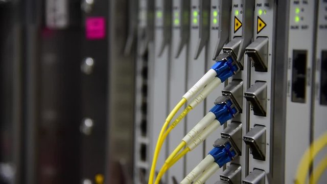Networking Temecommunication fiber optics cable patch cord connected and blinking of led status in data center