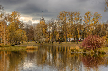 Autumn landscape in Victory Park and a house with a spire in the style of Stalinist Neoclassicism (Saint-Petersburg)