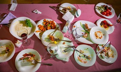 Leftover food after party, dirty food. After dinner. Concept of the restaurant business.