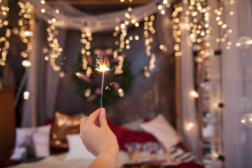 Night background with a star christmas sparkler. Sparkler Bokeh Colorful sparkler. Shallow focus