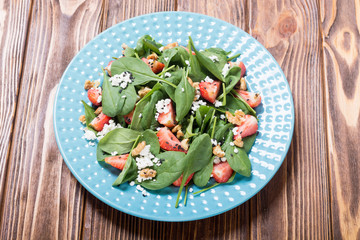 Strawberry salad with spinach , cheese and walnut