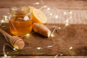 ingredients for making immunity boosting healthy vitamin drink on vintage wooden background, winter holiday christmas concept