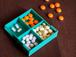 Colorful pills in a medicine box