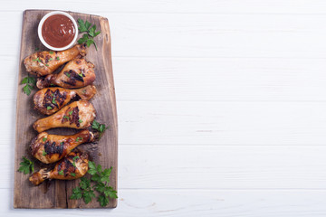 Grilled chicken legs with tomato sauce
