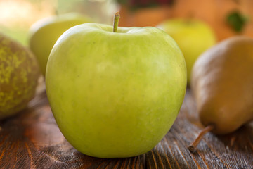 Apples of a pear, Pumpkin, viburnum, cones, nuts, acorns, chestnuts on a wooden background. Autumn composition by own hands