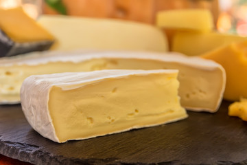Heads and pieces of cheese, brie masses, mozzarella, suluguni