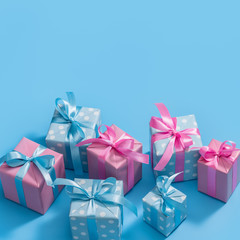  Stylish handmade gift boxes decorated with ribbons and bows. Gifts in pink and blue packaging.