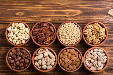 Mix of nuts : Pistachios, almonds , walnuts , pine nut , hazelnuts and cashew . Snack in bowl backgrond