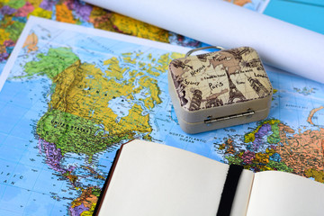 World map, drawings, notepad and suitcase. Travel and tourism.