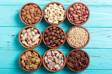 Mix of nuts : Pistachios, almonds , walnuts , pine nut , hazelnuts and cashew . Snack in bowl backgrond