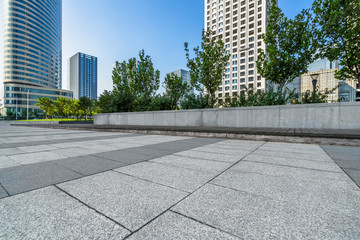 empty pavement and modern buildings in city.