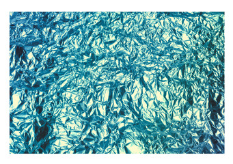 Blue crumpled foil texture isolated on white background