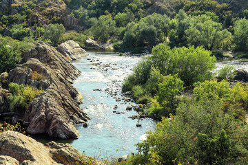 Naklejka na ściany i meble View of beautiful stream with rocky hills