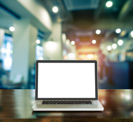 Blank white screen laptop computer with blur coffee shop on background