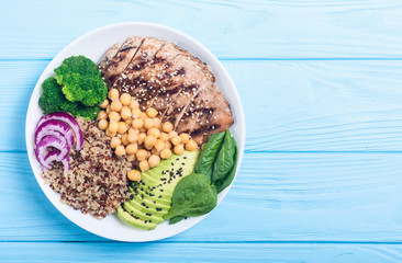 Buddha bowl with broccoli , quinoa , grilled chicken , avocado and spinach