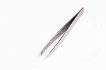 Metal tweezer on white background