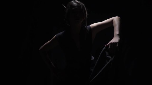 Unknown mysterious asian woman in the dark, slow motion