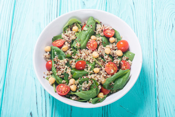 Spinach salad with quinoa , tomatoes and chickpea