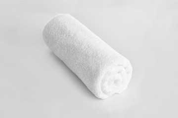 Fototapeta na wymiar Clean rolled towel on light background
